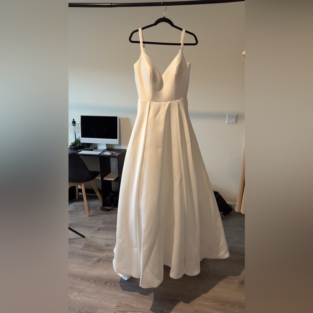 Tania Olsen Roma neck floor length a line. Mikado satin wedding gown